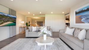 a living room with a couch and a table at Surf N Turf in Kiama