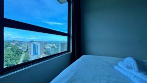 a bedroom with a window with a view of a city at JQ 合一民宿3 Unity Homestay 3 City Seaview 5pax in Kota Kinabalu +54 photos
