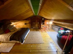 an attic room with a bed and a couch at Hacienda La Loma Cozy Retreat with Jacuzzi & Views in Cidra