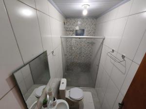 a white bathroom with a shower and a toilet at Estúdios VILA 5 Hotel, próximo a Praça dos Três Poderes in Brasilia +26 photos