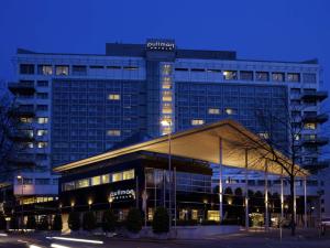 a building with a sign on the top of it at Pullman Cologne in Cologne