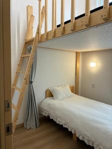 a bedroom with a bunk bed with a ladder at Niseko Yu Villa A in Niseko