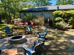 a group of chairs sitting around a fire pit in a yard at The Brewster Pearl in Brewster