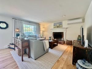 a living room with a couch and a fireplace at The Brewster Pearl in Brewster