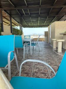 a patio with a table and chairs on a building at Departamento zona Diamante in Acapulco +22 photos