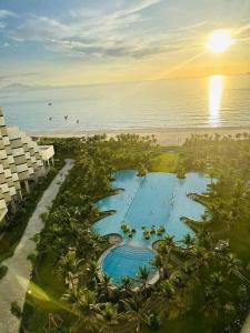 an aerial view of a resort swimming pool and the beach at ARENA JKV condotel in Nha Trang