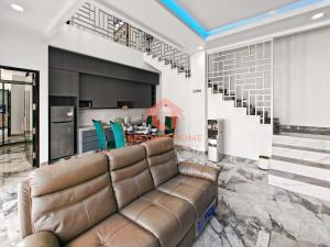 a living room with a leather couch and a kitchen at Luxury 3BR Krobokan Villa A Pool & Wi-Fi in Kerobokan