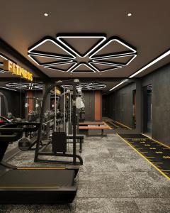 a gym with a treadmill and weights in a building at L'Heritage Premium Hanoi Central in Hanoi