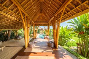 an open pavilion with a pool in a resort at Rumah Kita Ecolodge in Ubud