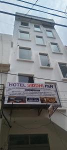 a building with a hotel scholar inn sign on it at Siddhi inn in Gangānagar +23 photos