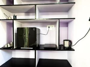 a tv sitting on a shelf in a room at NAKSHATHRA Guest House 2BHK in Tiruvannāmalai