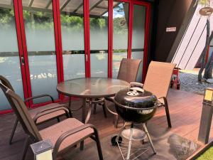 a patio with a grill and a table and chairs at Gapyeong The Haru Emotional Pool Villa in Mŏk-kol