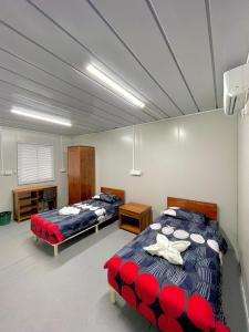 a room with two beds in a room at Timor Lodge in Dili +47 photos
