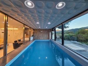 einen Pool in einem Haus mit Aussicht in der Unterkunft Gapyeong Pool Villa Pension Belloci Lake in Hakik-tong