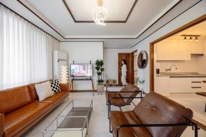 a living room with a couch and a table at Asan Wolang Stay in Asan