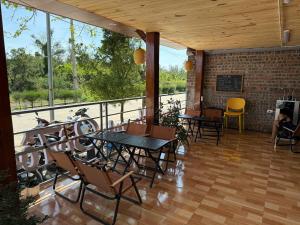 a patio with tables and chairs on a balcony at Honey Homes Cô Tô in Đảo Cô Tô