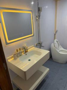 a bathroom with a sink and a toilet at Honey Homes Cô Tô in Đảo Cô Tô +77 photos