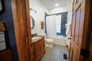a bathroom with a sink and a toilet and a tub at Cozy 3-Bedroom Grand Chalet in Delta +30 photos