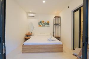a bedroom with a bed in a room at 4BR Modern Villa walking dist to Sidewalk Jimbaran in Jimbaran +25 photos
