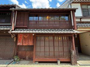 a house with two doors and a balcony at 椿とことは in Obama