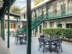 a row of tables and chairs on a patio at ibis Levallois Perret in Levallois-Perret