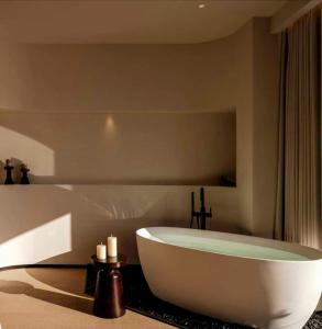 a large bath tub in a bathroom with candles at YS Seaview Hotel in Dali