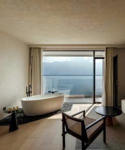 a bath tub in a bathroom with a large window at YS Seaview Hotel in Dali