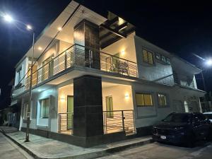 a house with a car parked in front of it at night at Casa Lujosa, Catemaco, Ubicación Céntrica in Catemaco