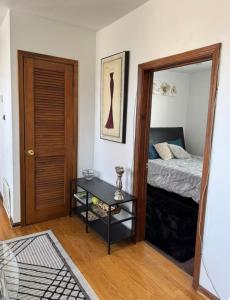 a bedroom with a bed and a table with a mirror at Location! Location! 2bd 1bth spacious apartment! in Chicago