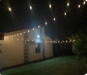 a group of lights hanging over a garage at night at Aileen Homestay Swimming Pool in Batu Gajah