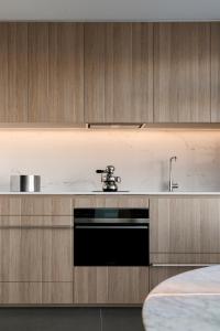 a kitchen with a sink and a dishwasher at Breathtaking Sydney Harbour Views from Stylish Harbourside Studio in Sydney
