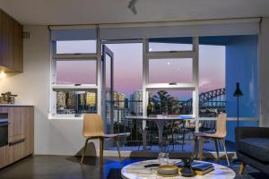 a kitchen and living room with a view of a city at Breathtaking Sydney Harbour Views from Stylish Harbourside Studio in Sydney