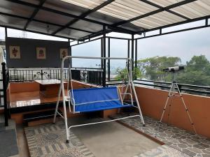 a room with a bed and a camera on a balcony at Villa Sakinah Ciwidey in Bandung