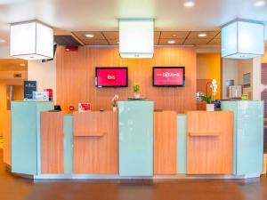 a lobby of a store with wooden walls at Ibis Como in Grandate