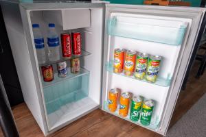an open refrigerator filled with drinks and soda at Hotel Dreamworld Araneta Cubao in Manila