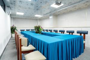 a conference room with blue tables and chairs at W Premium Nha Trang in Nha Trang +94 photos