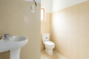 a bathroom with a toilet and a sink at CTC Receptions in Anuradhapura +63 photos