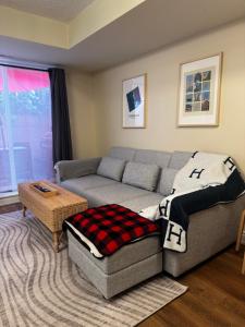 a living room with a couch and a table at DT Townhome 1BR steps to transit in Toronto