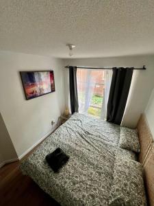 a small bedroom with a bed and a window at DT Townhome 1BR steps to transit in Toronto