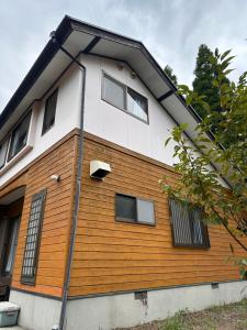 una casa de color marrón y blanco en 閼宗屋 Asoya, en Takamori