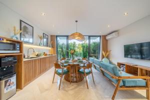 a kitchen and living room with a table and chairs at Townhouse T1 - Hidden Gem in Ubud -Townhouse in Ideal Location in Ubud +10 photos
