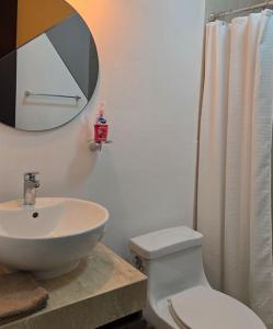 a bathroom with a sink and a toilet and a mirror at Paraíso Liverte Cancún 603 in Cancún +4 photos