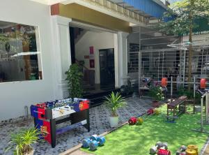 a house with a yard with toys on the lawn at CATBA PANDORA Hotel & Travel in Cat Ba
