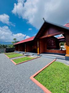 a building with some grass in front of it at Mana Gramam Resort Mudumalai in Mudumalai National Park
