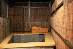 an empty room with a table and a brick wall at いろどり荘 in Imabari