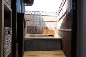 a view of a bathroom with a sink and a fence at いろどり荘 in Imabari