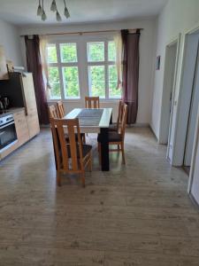 a kitchen and dining room with a table and chairs at Haus am Wendsee in Brandenburg an der Havel