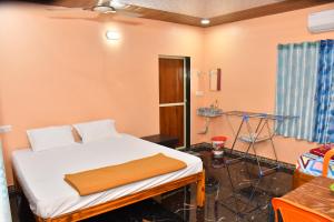 a hospital room with a bed and a table at Shivai holiday home in Alibaug
