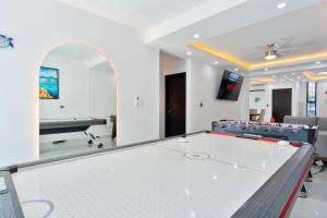 a ping pong table in a room with a pool table at Luxury home-heated Pool-2bedroom in Cancún