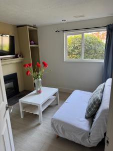 a living room with a couch and a table with flowers at sweet home in Delta